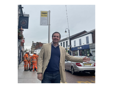 Photo of Chris at a bus stop in Westhoughton